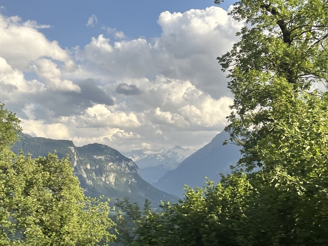       Mountain ranges with clouds in the sky.
  