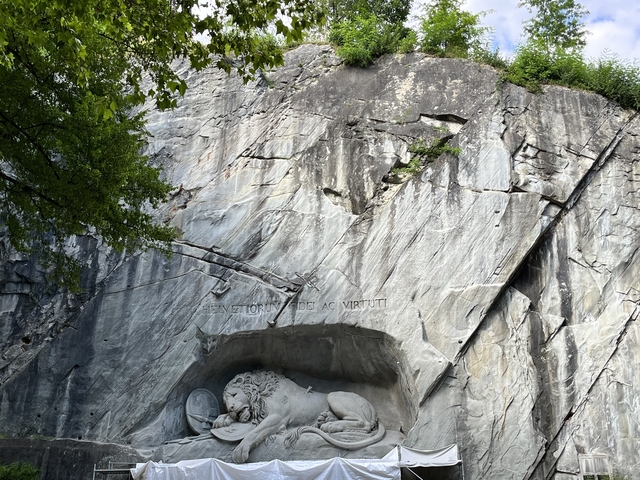       Lion Monument carved in a rock face.
  