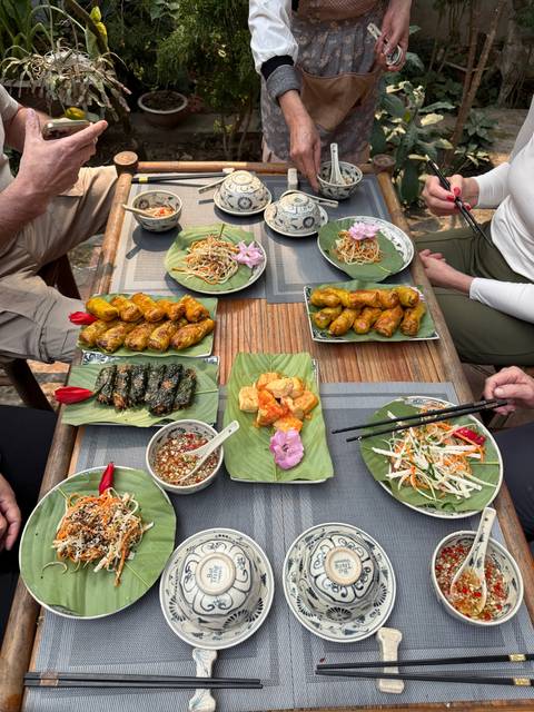       An array of traditional dishes served on green leaves.
  