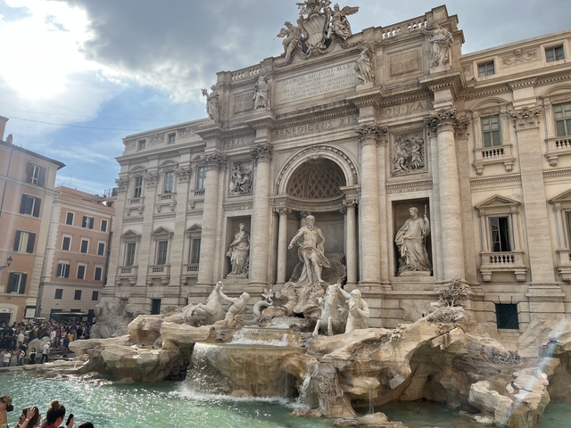 Trevi Fountain in Rome with a gathering of tourists.