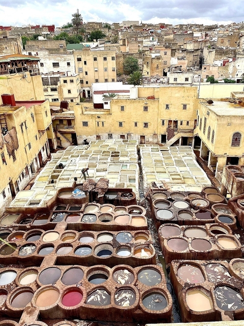 A traditional tannery with various dyeing vats.