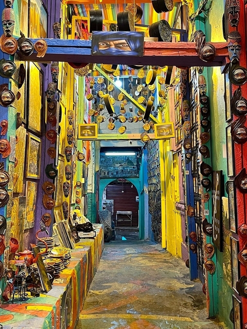 A corridor filled with colorful art and masks.