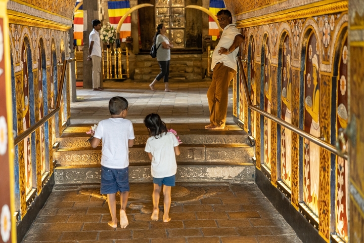 Children exploring an ornate temple interior.