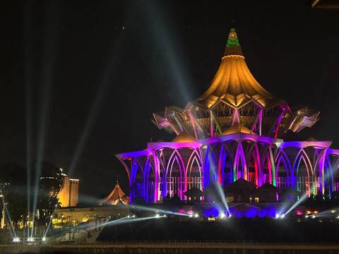       Beautifully lit building with colorful lights at night.
  
