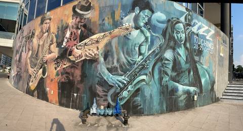       Colorful mural depicting musicians on a wall.
  