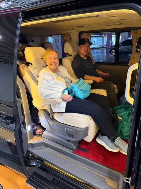 Passengers sitting in a vehicle interior.