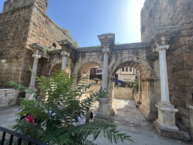      Historical stone arches with greenery.
  