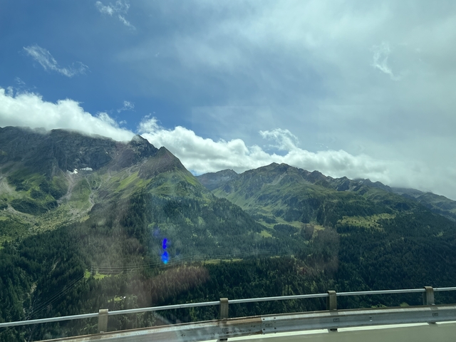       Mountainous landscape with patches of sunlight.
  