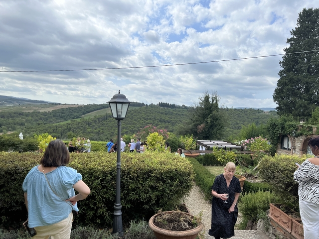       People strolling in a garden with a scenic view.
  