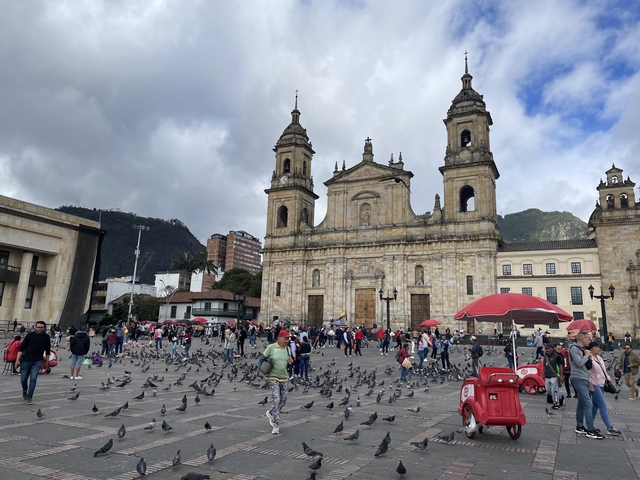       Historic cathedral with people in a square
  