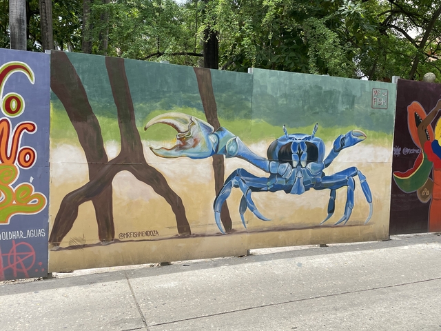      Colorful mural of a blue crab on a wall
  