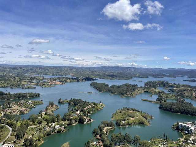       Panoramic view of a lake with islands and hills
  