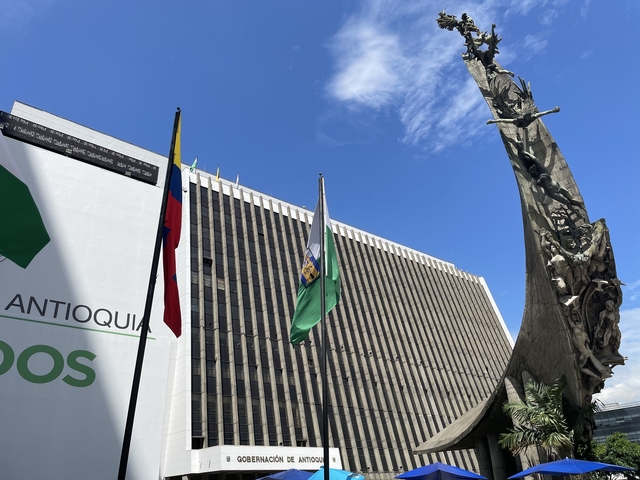       Building with flags of Colombia and other places
  