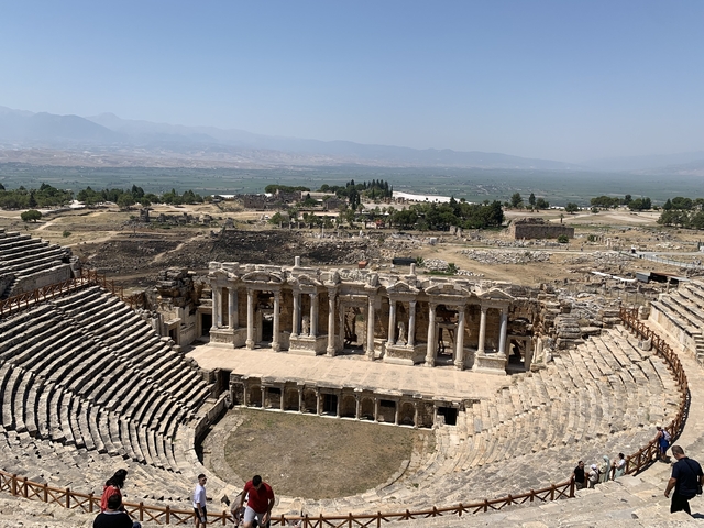 Ancient theatre in Pamukkale with surrounding ruins.