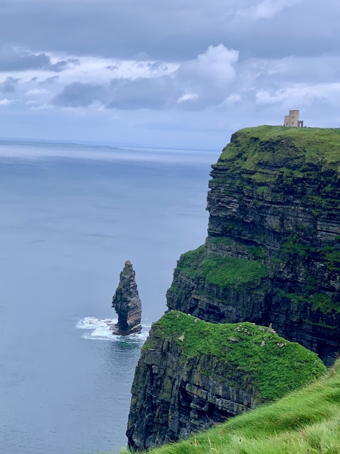 Cliffs by the sea with a lone rock stack.