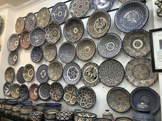       Wall display of decorative plates with intricate designs.
  