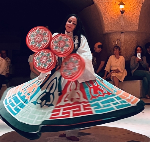       Traditional dance performance with people watching.
  
