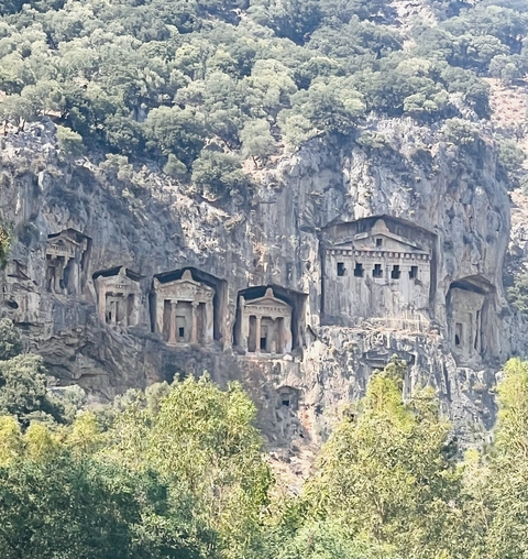       Ancient rock-cut tombs in a cliff.
  