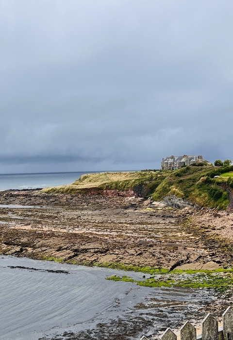 Coastal landscape with a house on a cliff.