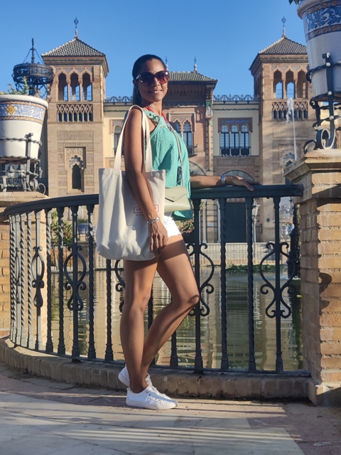       Elegant woman posing on a pedestrian bridge.
  