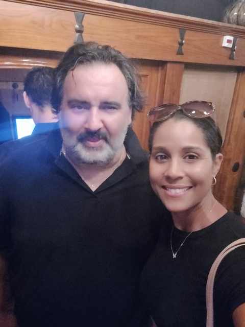      Close-up selfie of two people smiling.
  