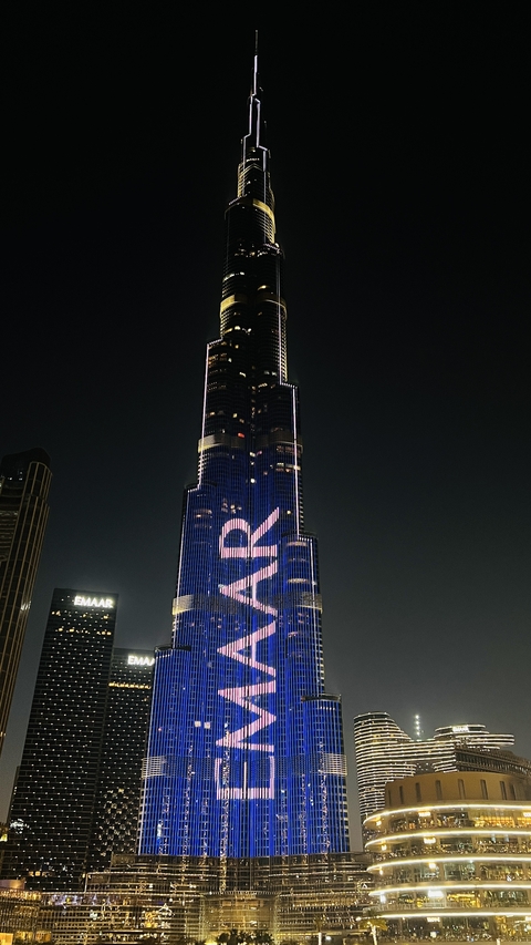       Illuminated skyscraper against a night sky.
  