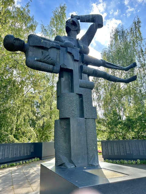       Abstract statue amidst trees.
  