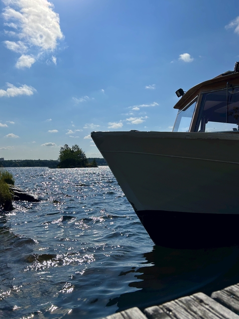       Bow of a boat in a sparkling lake.
  