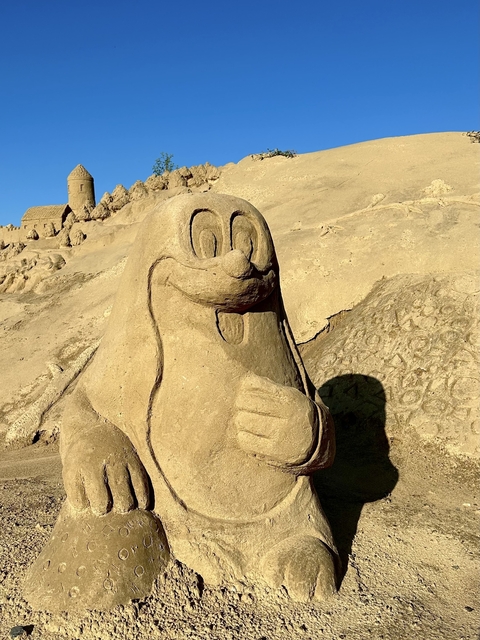       Sand sculpture of a cartoon character.
  