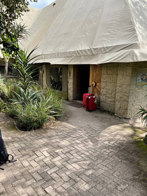       Accommodation entrance with a red suitcase.
  