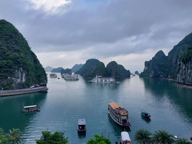 Scenic view of limestone karsts and boats in Halong Bay.