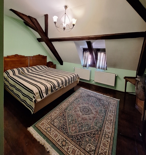 Simple attic bedroom setup with a cozy atmosphere.