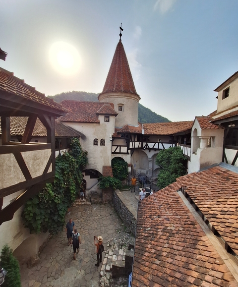 Historic interior courtyard with tourists exploring.