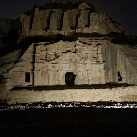       Nighttime view of an ancient rock-cut monument.
  