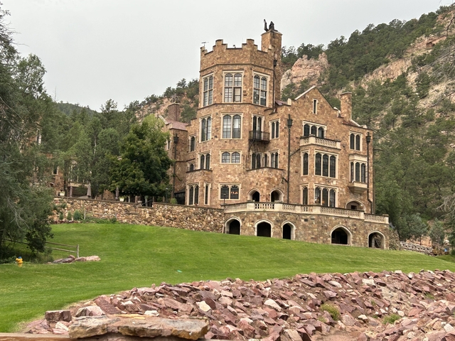       A large historic building in the mountains.
  