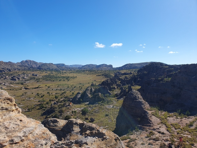 Rocky landscape with blues skies and distant mountains.