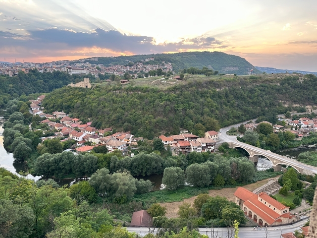 Aerial view of a town nestled in a valley with a river.