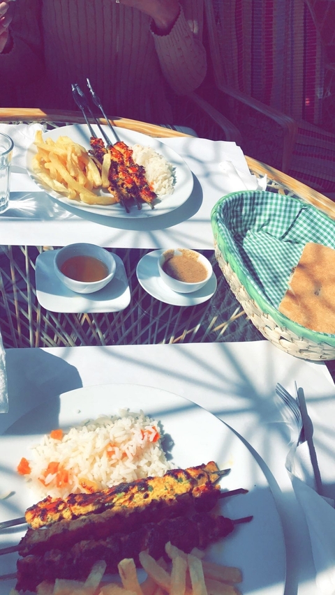       Breakfast table with tea and pastries.
  
