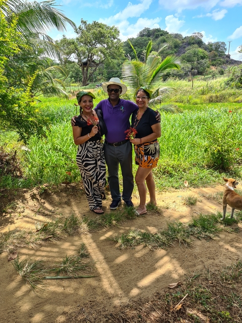       Three people standing in a field.
  