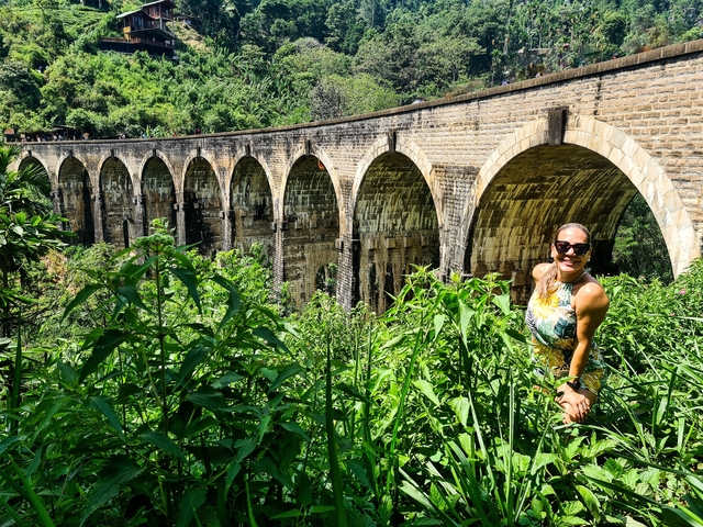Woman posing in front of Nine Arches Bridge.