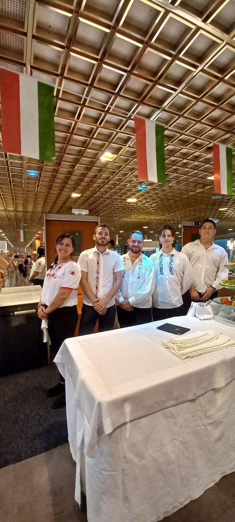 Group of people in traditional attire indoors.