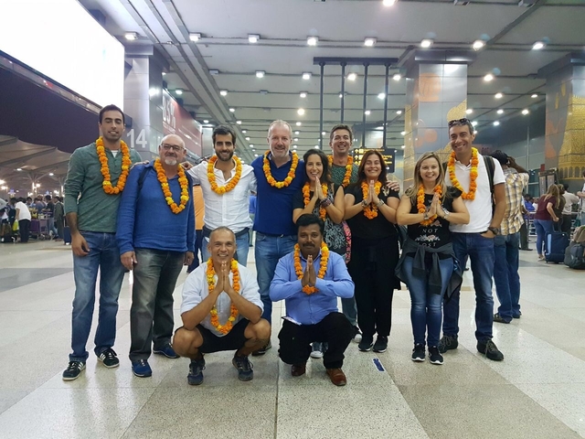 Group with mountains in the background at an airport.