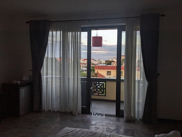 View through a balcony door with curtains.