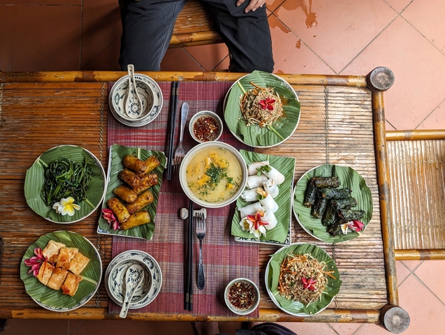       Traditional Vietnamese meal on bamboo table.
  
