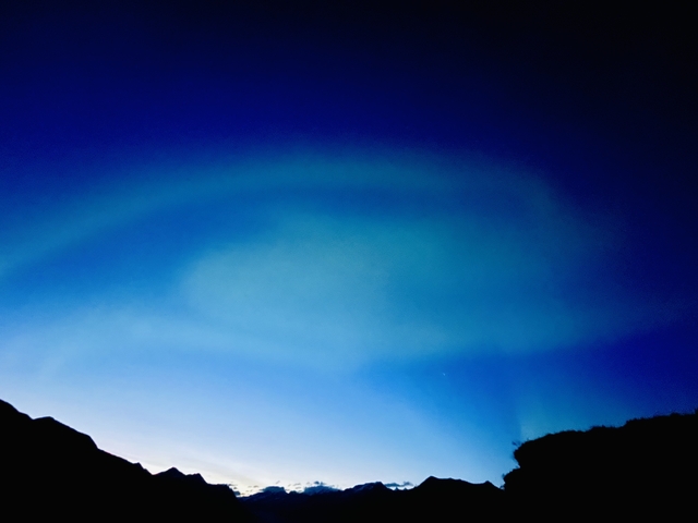       Soft blue aurora in the night sky
  