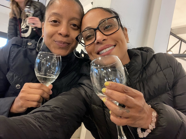 Two people with wine glasses indoors