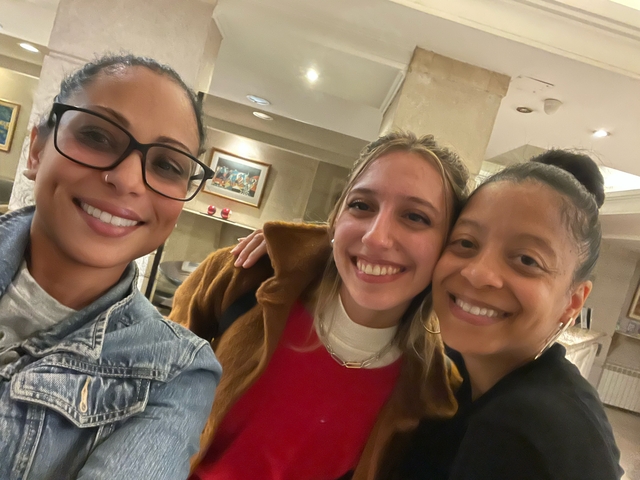       Three women posing together indoors
  