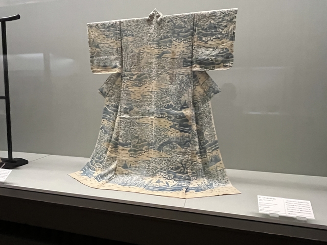       A kimono on display with intricate designs.
  