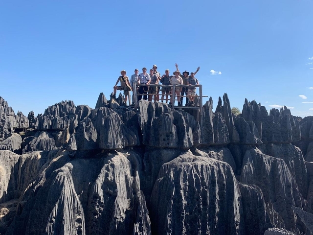       Group of people standing on limestone pinnacles.
  