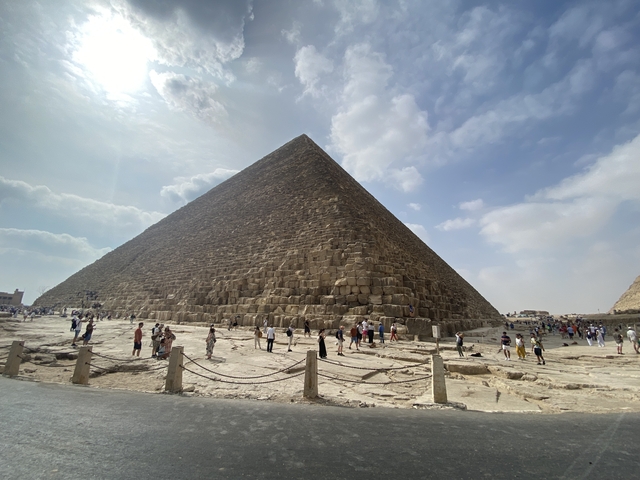Large pyramid structure with visitors around.